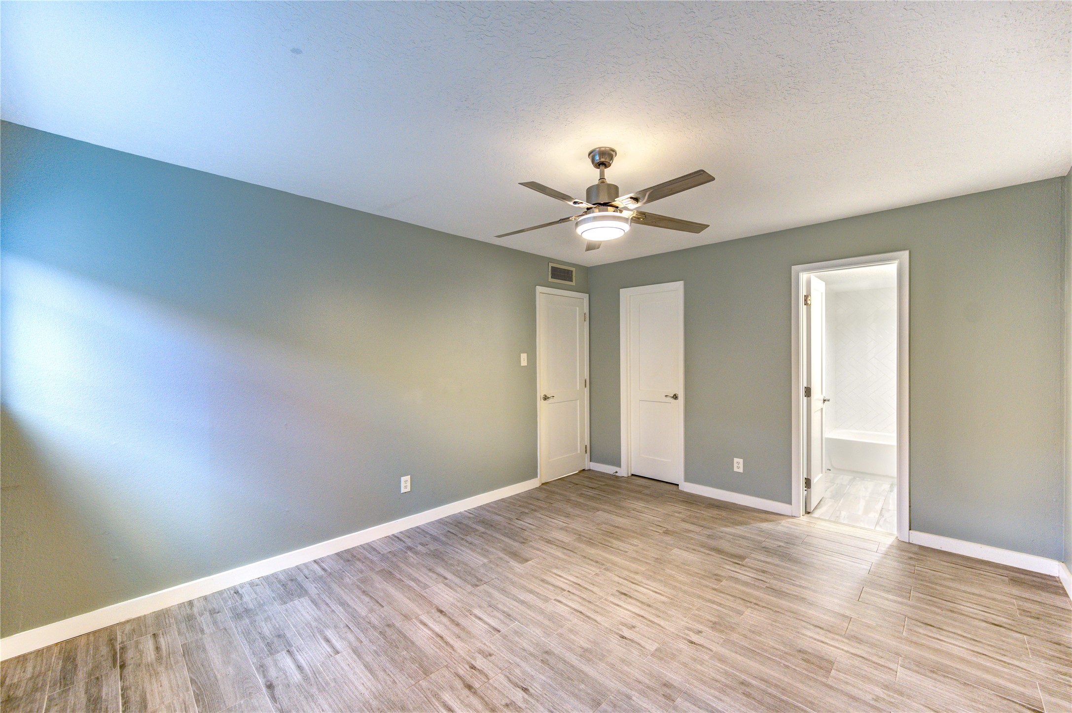 3224 Timmons Lane, Unit 155 Houston, TX 77027 - Photo 30 of 50 a view of an empty room with wooden floor
