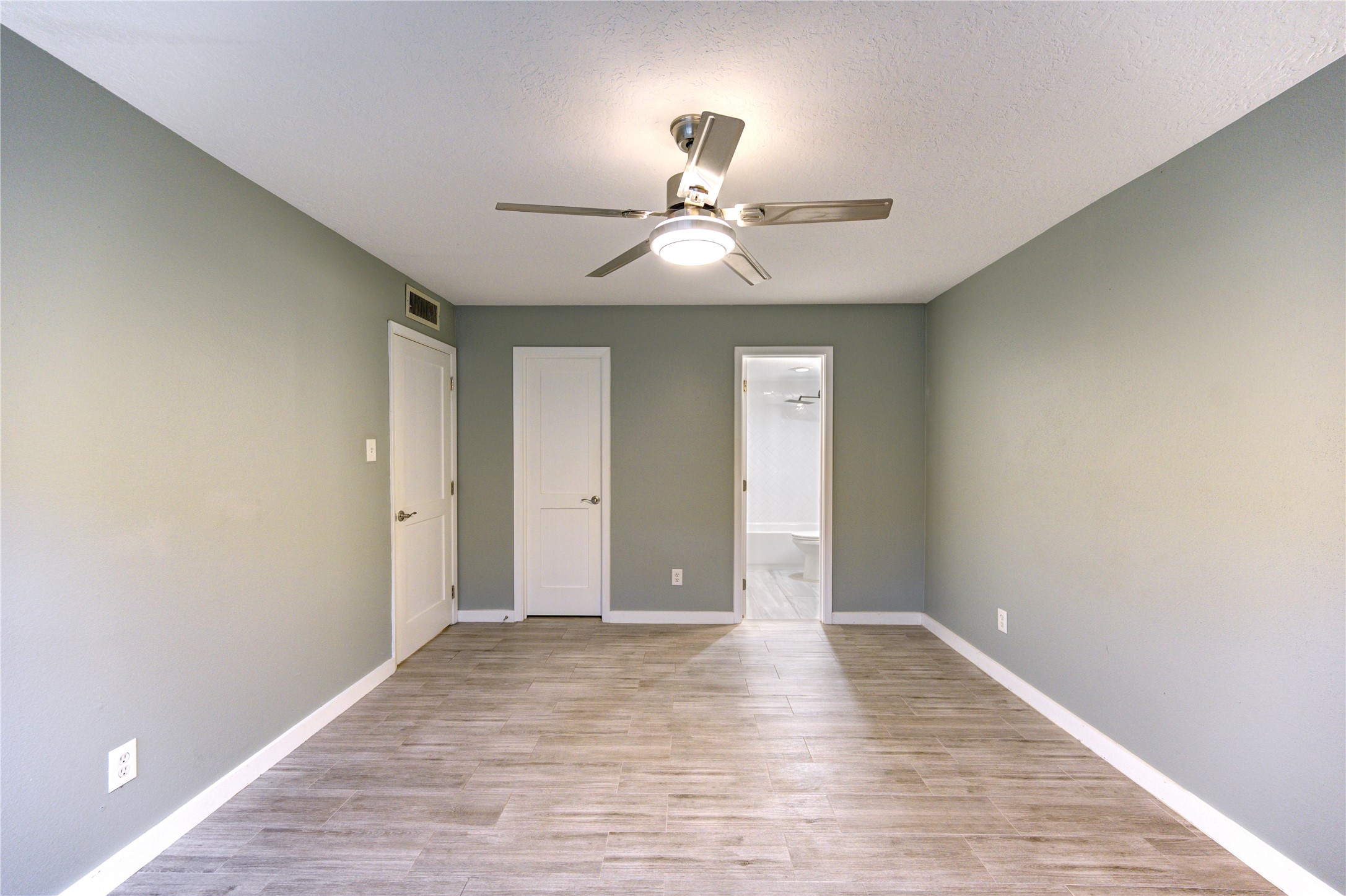 3224 Timmons Lane, Unit 155 Houston, TX 77027 - Photo 31 of 50 a view of an empty room with window and wooden floor