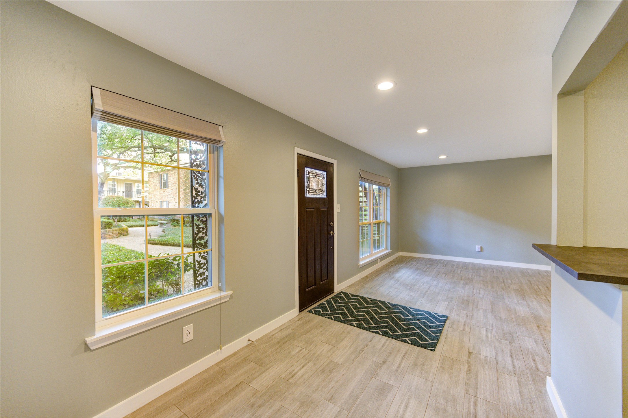 3224 Timmons Lane, Unit 155 Houston, TX 77027 - Photo 6 of 50 a view of an empty room with wooden floor and a window
