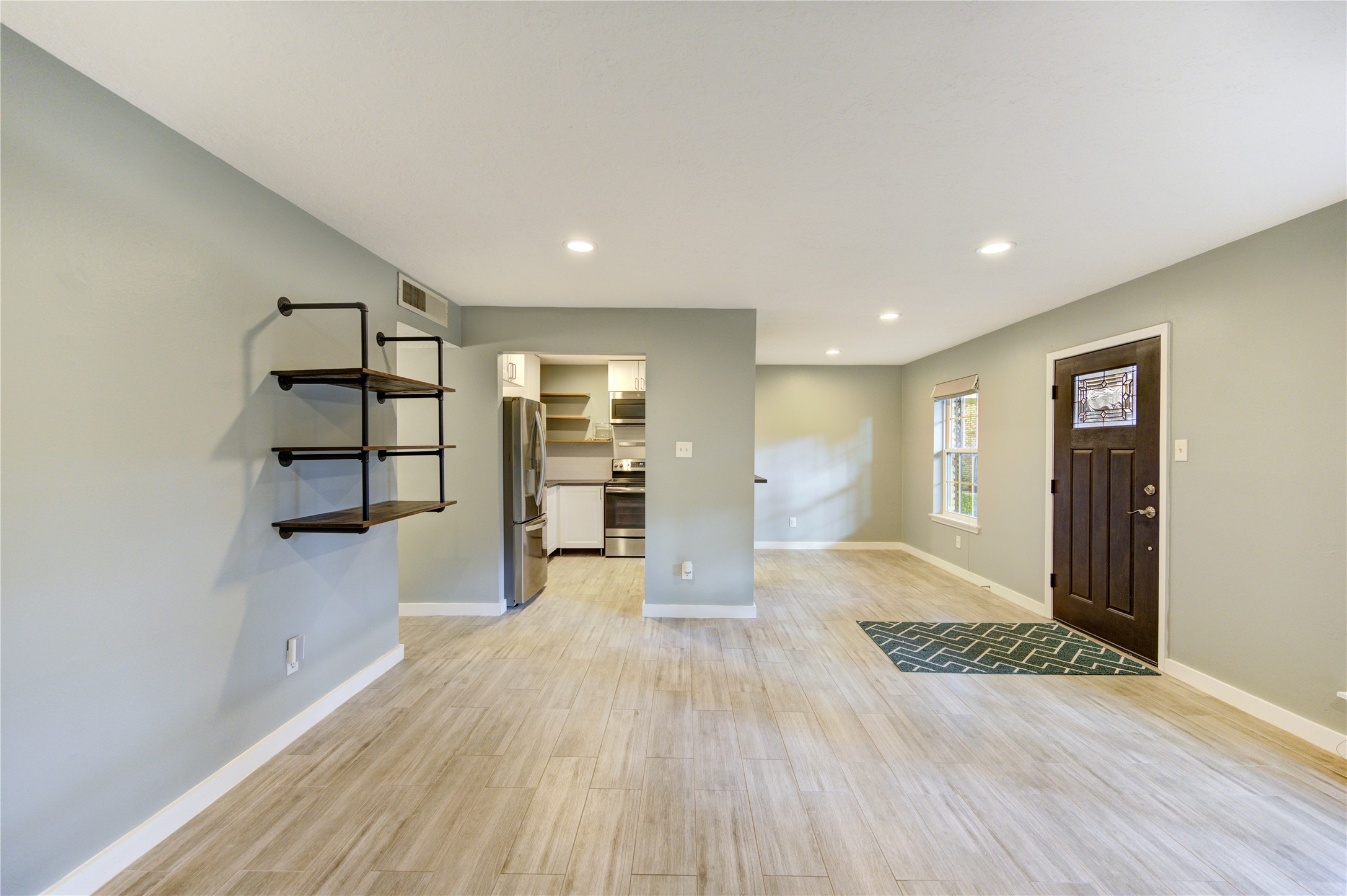 3224 Timmons Lane, Unit 155 Houston, TX 77027 - Photo 8 of 50 a view of a room with wooden floor and windows