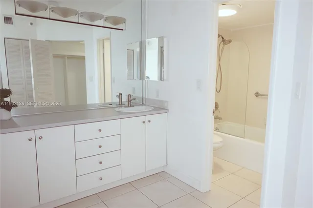 a bathroom with a bath tub with a shower