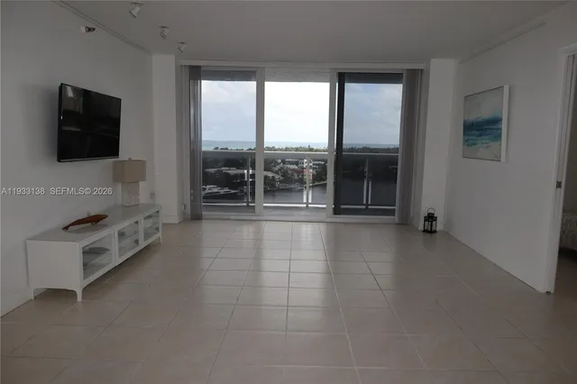 a dining room with furniture and a flat screen tv
