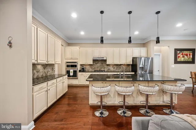 a view of kitchen with refrigerator dining table and chairs