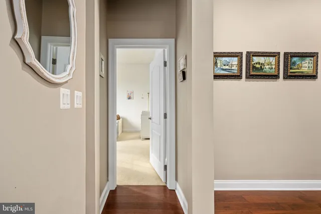 a bathroom with a granite countertop sink a toilet a mirror and shower