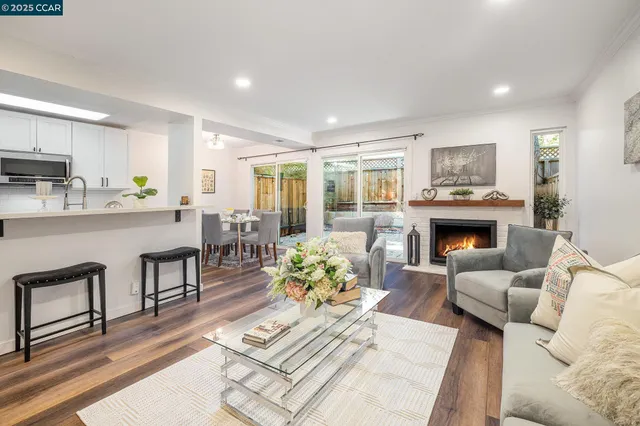 a living room with furniture fireplace and dining table