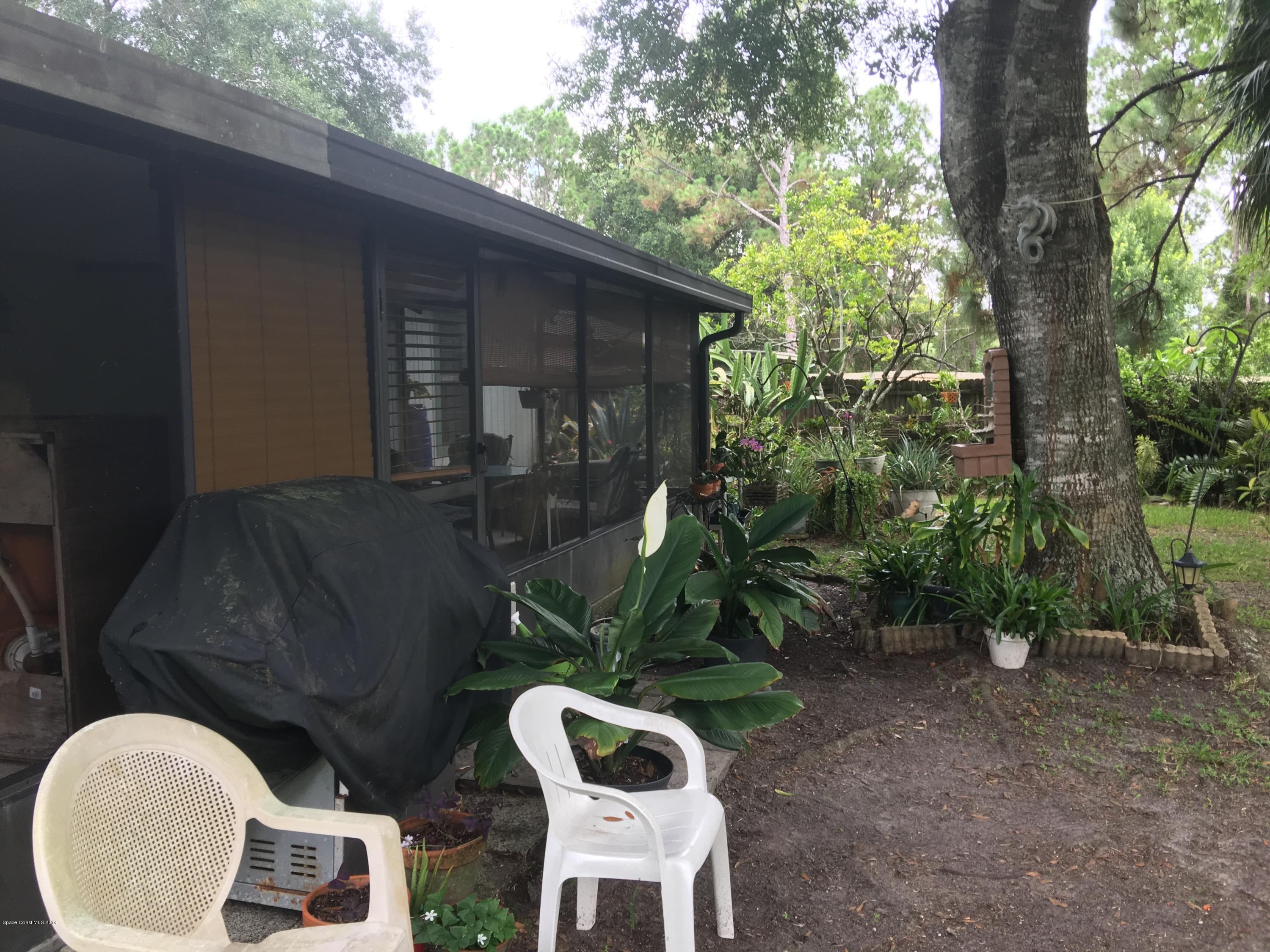 170 Santa Rosa Avenue Southwest Palm Bay, FL 32908 - Photo 21 of 32 Grill and sitting area under the trees