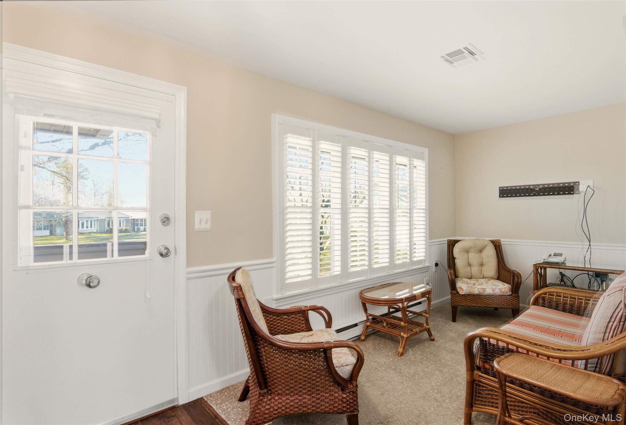 360 Woodbridge Drive, Unit A Ridge, NY 11961 - Photo 13 of 34 a living room with furniture and two window