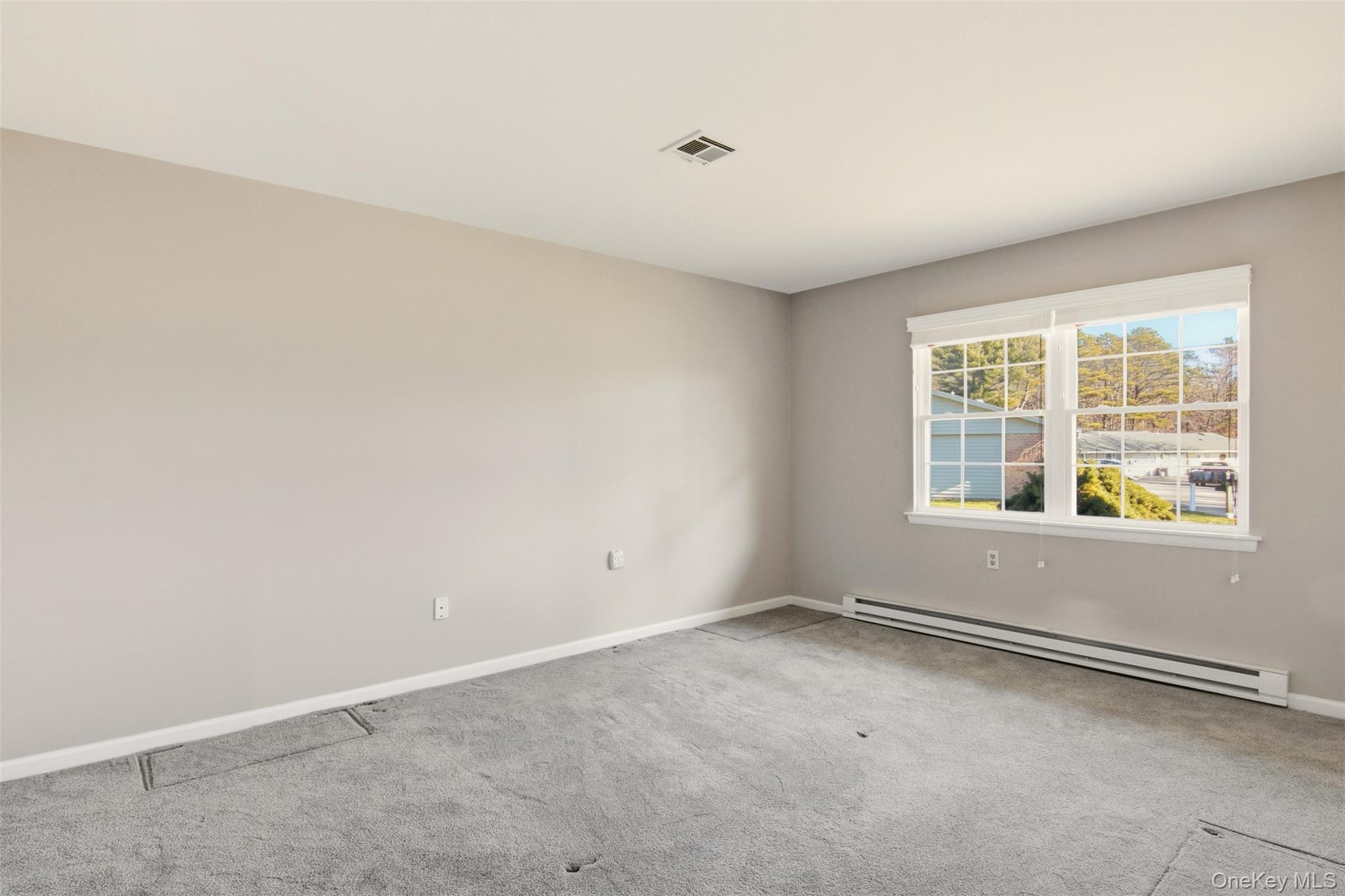 360 Woodbridge Drive, Unit A Ridge, NY 11961 - Photo 15 of 34 an empty room with windows