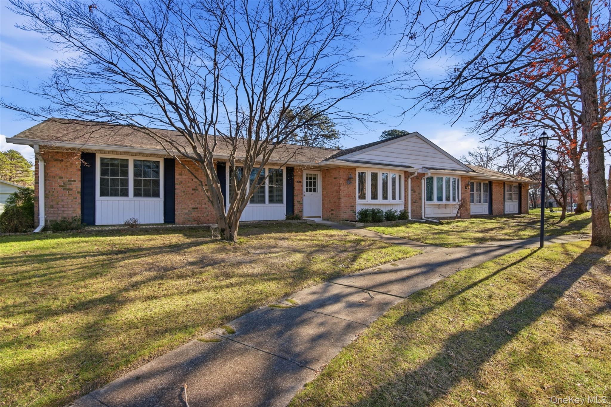 360 Woodbridge Drive, Unit A Ridge, NY 11961 - Photo 23 of 34 a view of a house with a yard