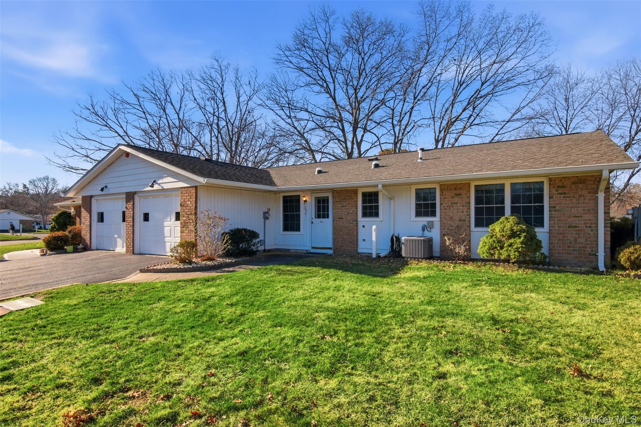 360 Woodbridge Drive, Unit A Ridge, NY 11961 - Photo 24 of 34 a front view of house with yard and green space