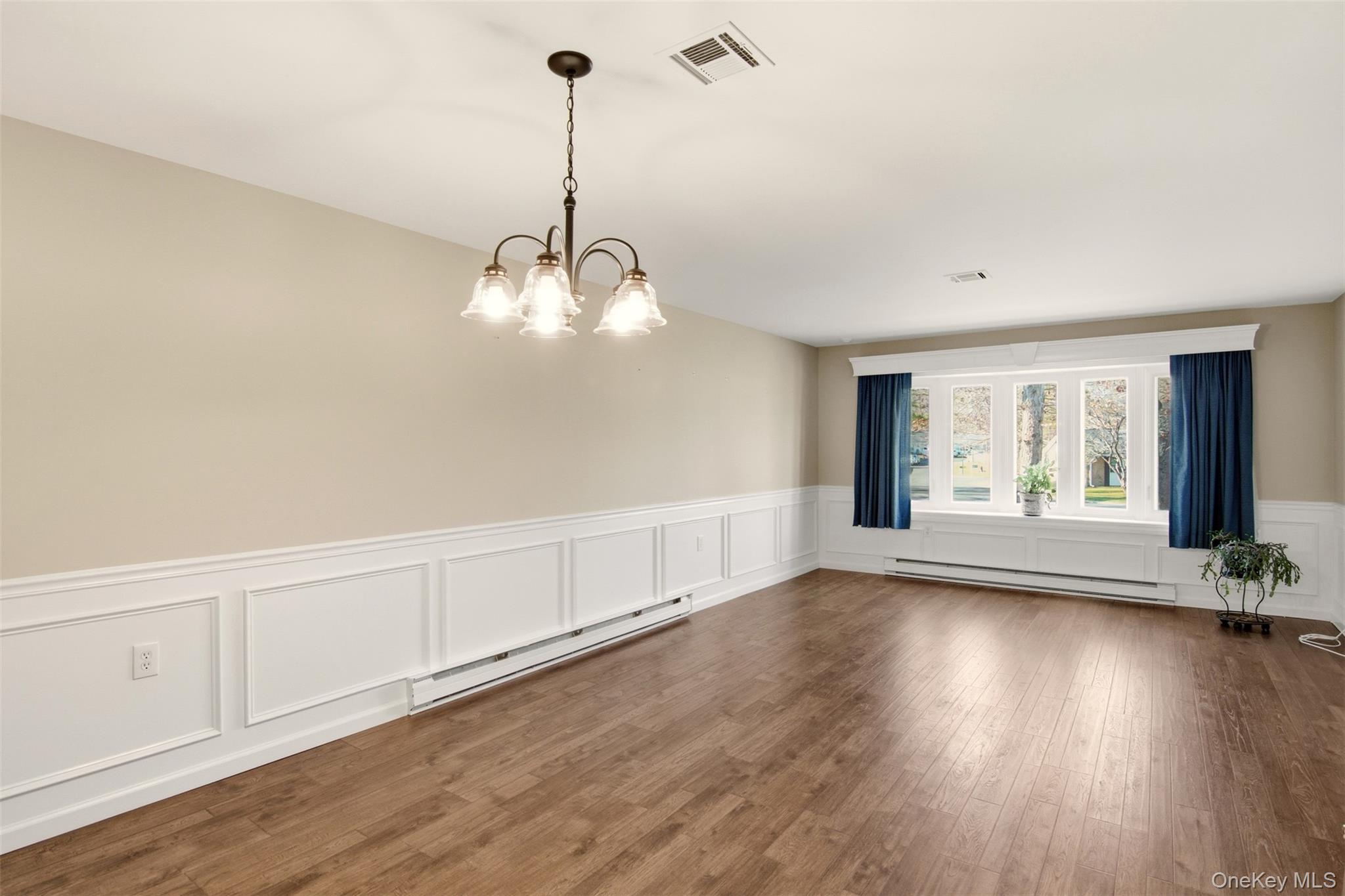 360 Woodbridge Drive, Unit A Ridge, NY 11961 - Photo 3 of 34 a view of an empty room with wooden floor and a window