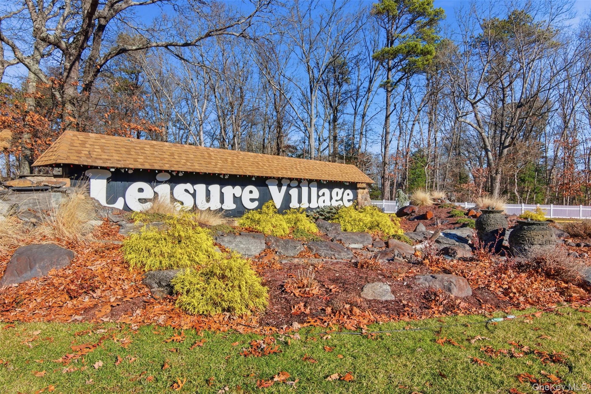360 Woodbridge Drive, Unit A Ridge, NY 11961 - Photo 33 of 34 a view of a house with a yard and sitting area
