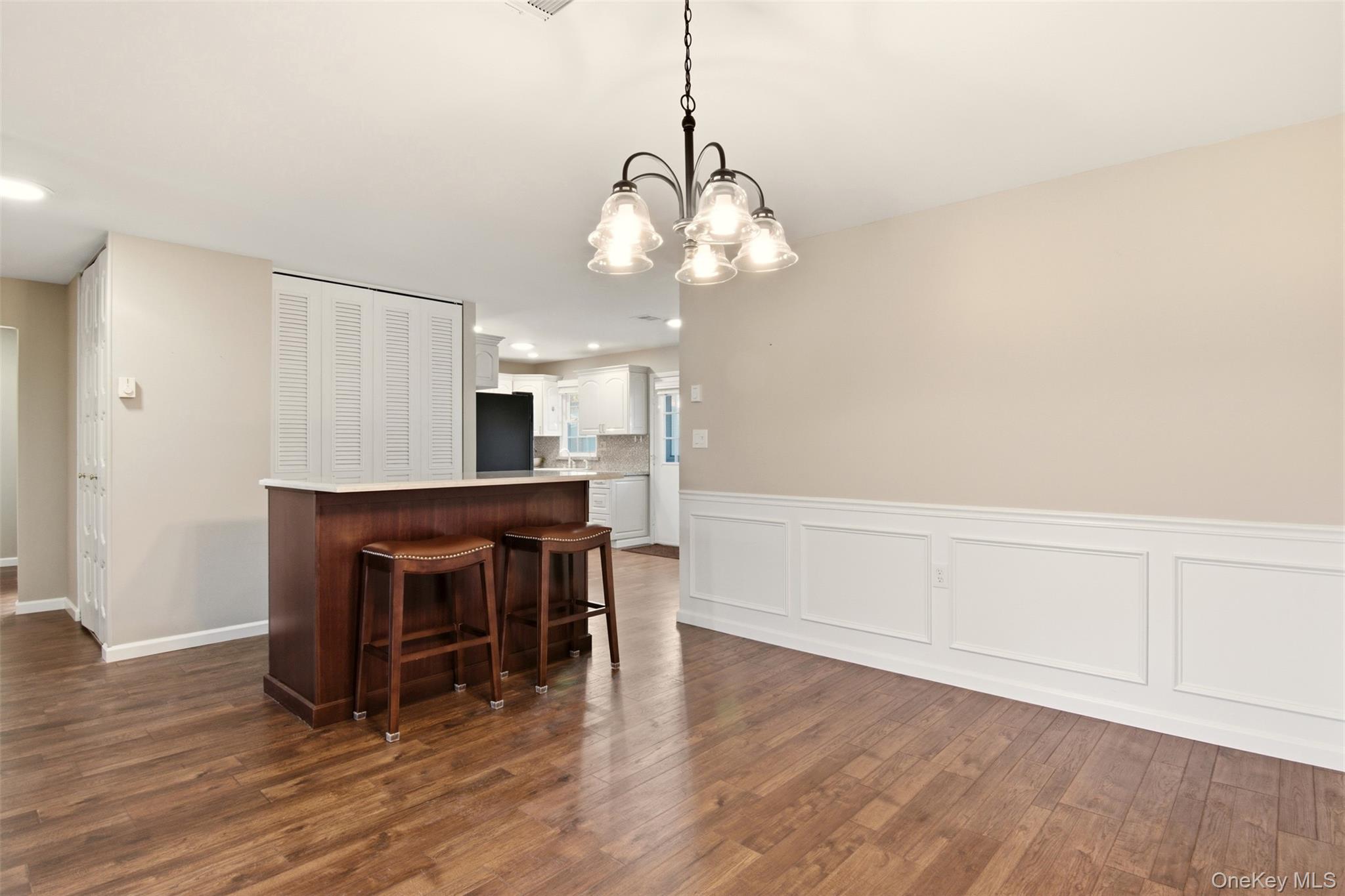 360 Woodbridge Drive, Unit A Ridge, NY 11961 - Photo 4 of 34 a view of a dining room with furniture and wooden floor