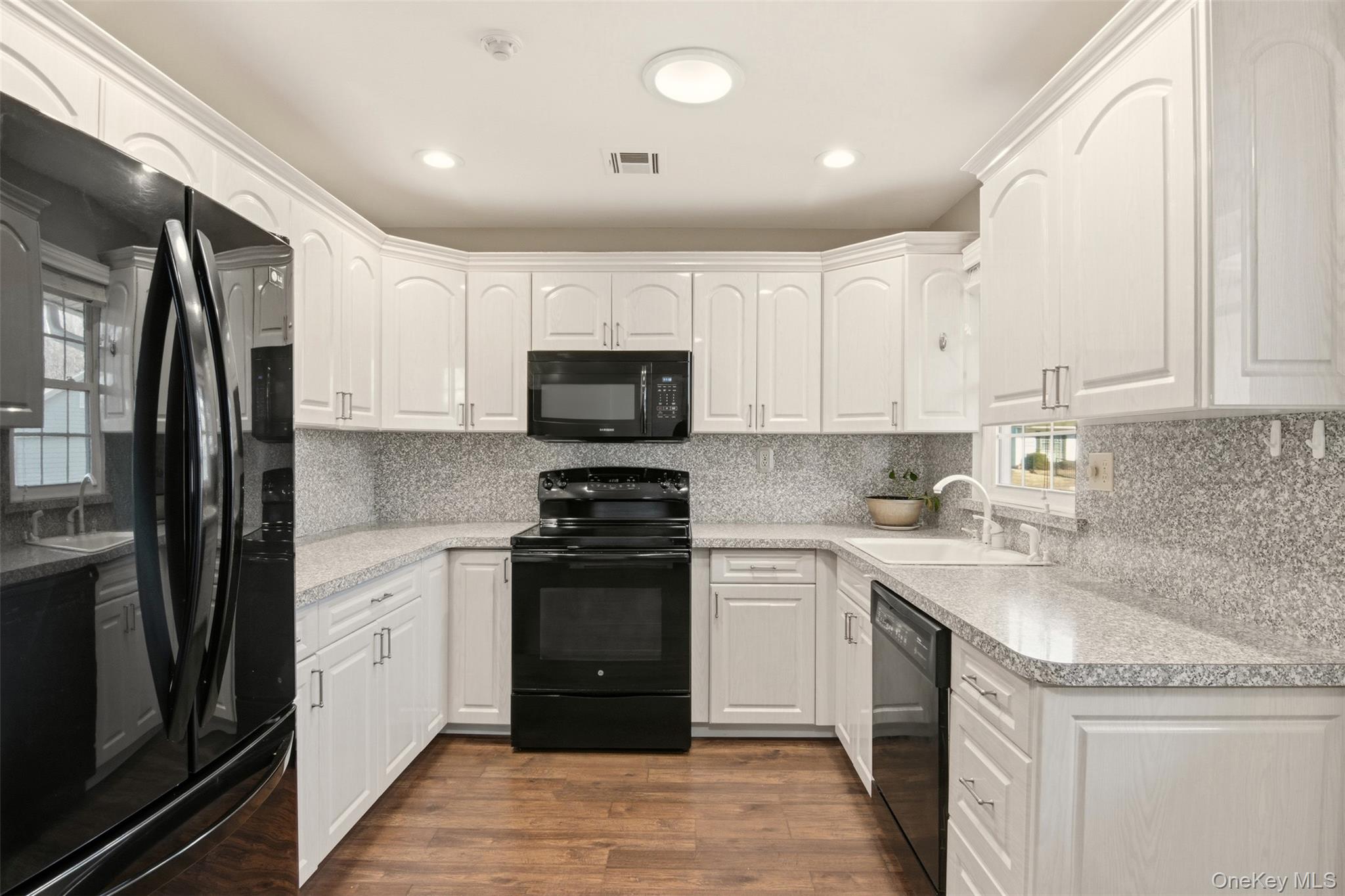 360 Woodbridge Drive, Unit A Ridge, NY 11961 - Photo 7 of 34 a kitchen with stainless steel appliances granite countertop a refrigerator sink and stove