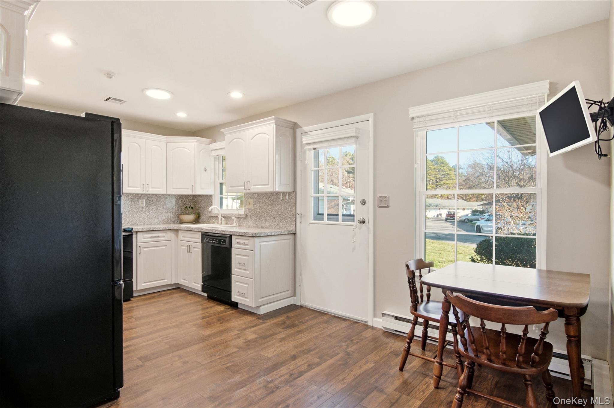 360 Woodbridge Drive, Unit A Ridge, NY 11961 - Photo 8 of 34 a kitchen with a table and chairs in it