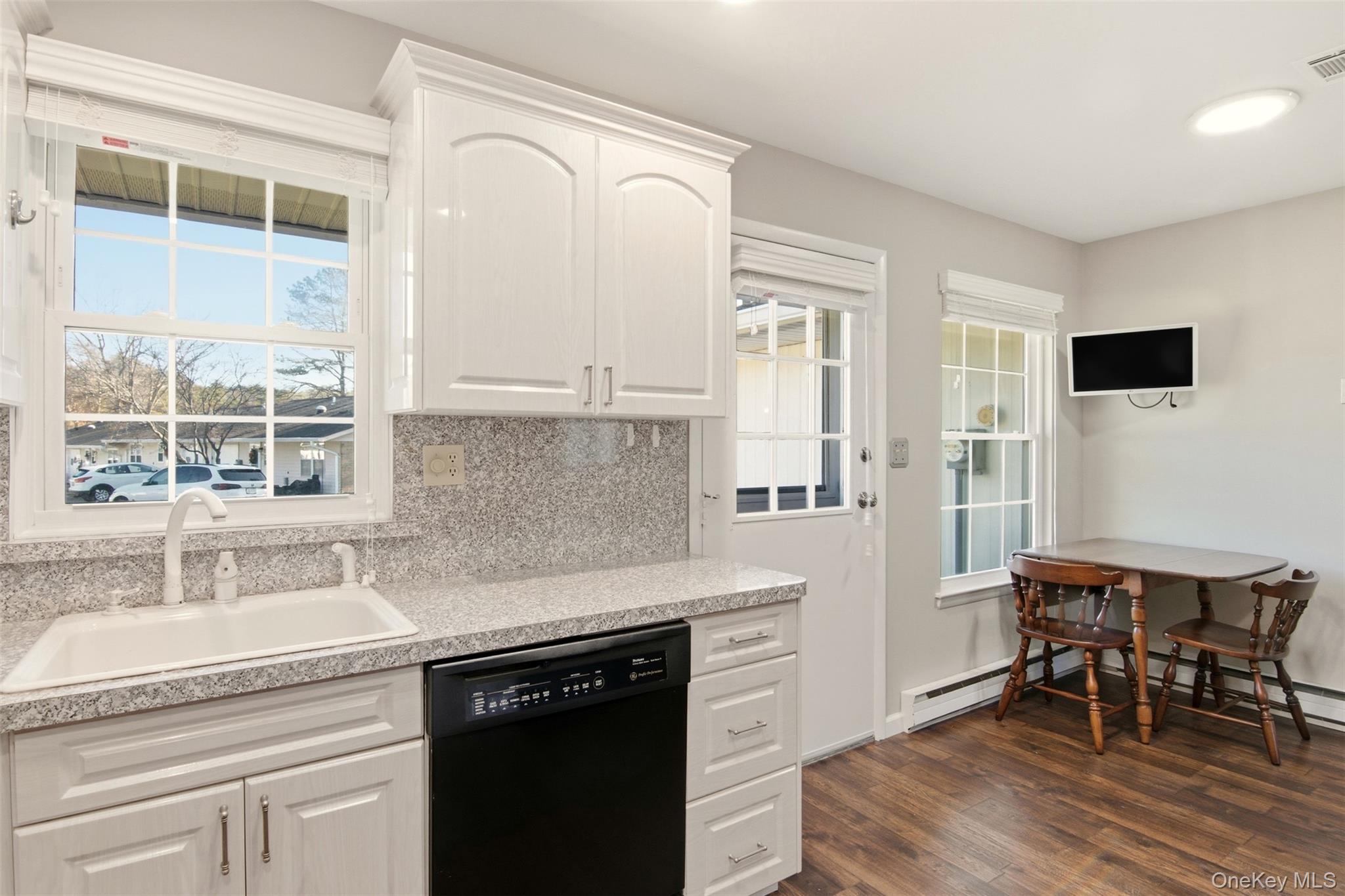 360 Woodbridge Drive, Unit A Ridge, NY 11961 - Photo 9 of 34 a kitchen with granite countertop a sink cabinets and window