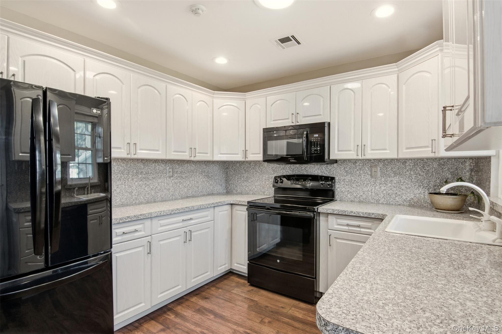 360 Woodbridge Drive, Unit A Ridge, NY 11961 - Photo 10 of 34 a kitchen with a sink stove and refrigerator
