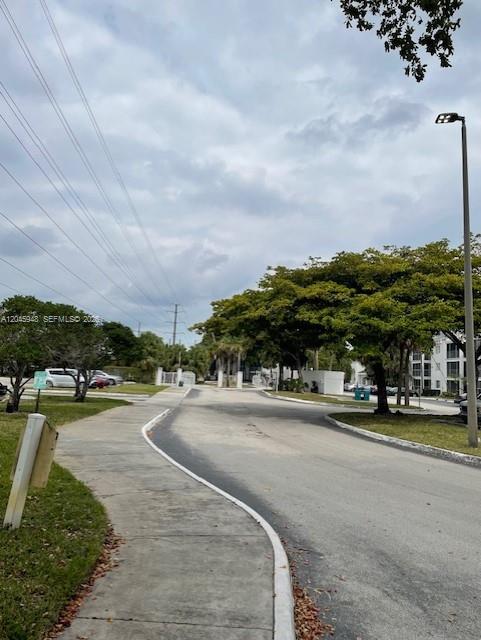5612 Rock Island Road, Unit 167 Tamarac, FL 33319 - Photo 14 of 16 a view of a city street and a car parked