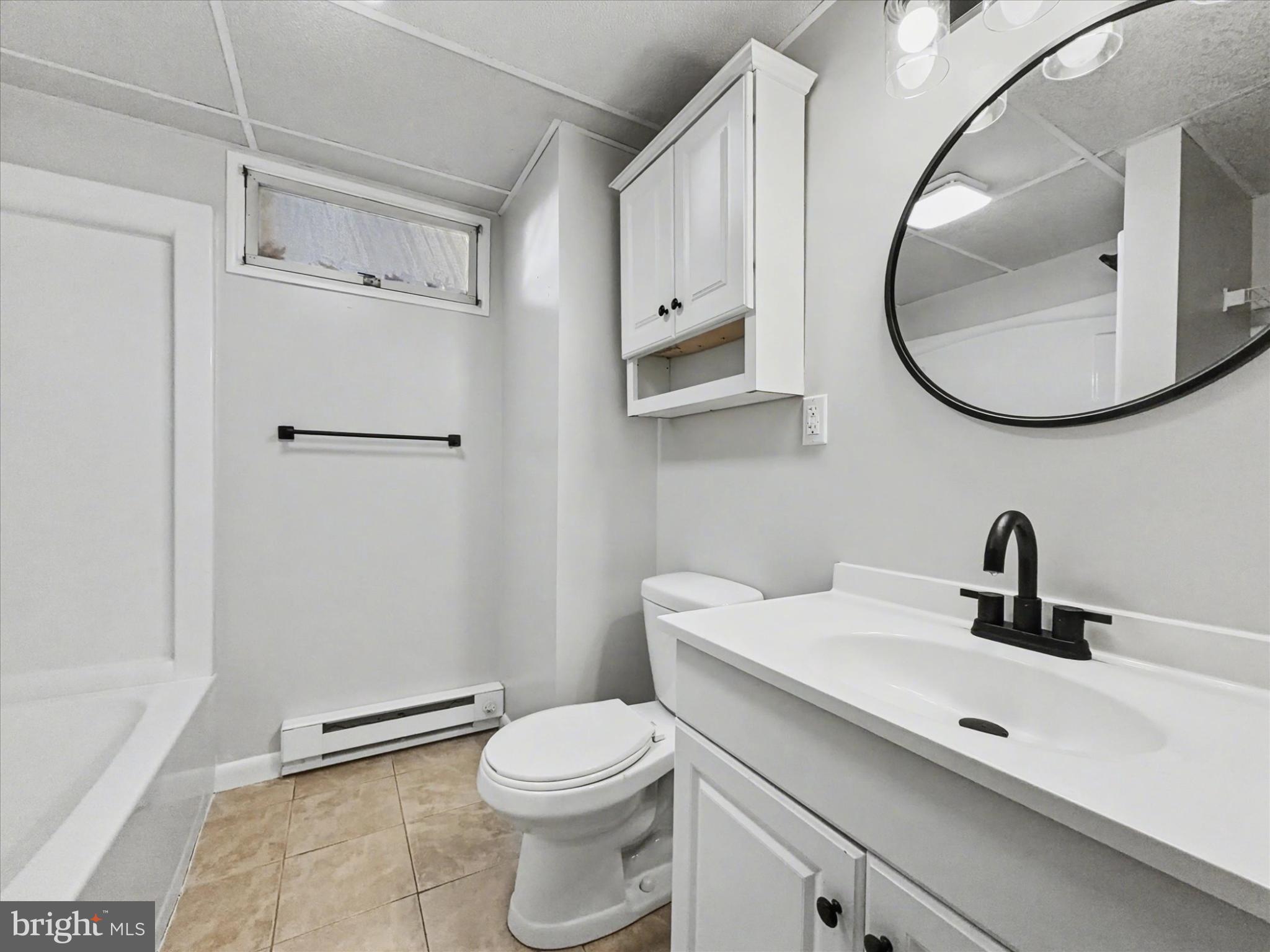 2196 South Queen Street York, PA 17402 - Photo 20 of 28 a bathroom with a sink a mirror a toilet and a shower