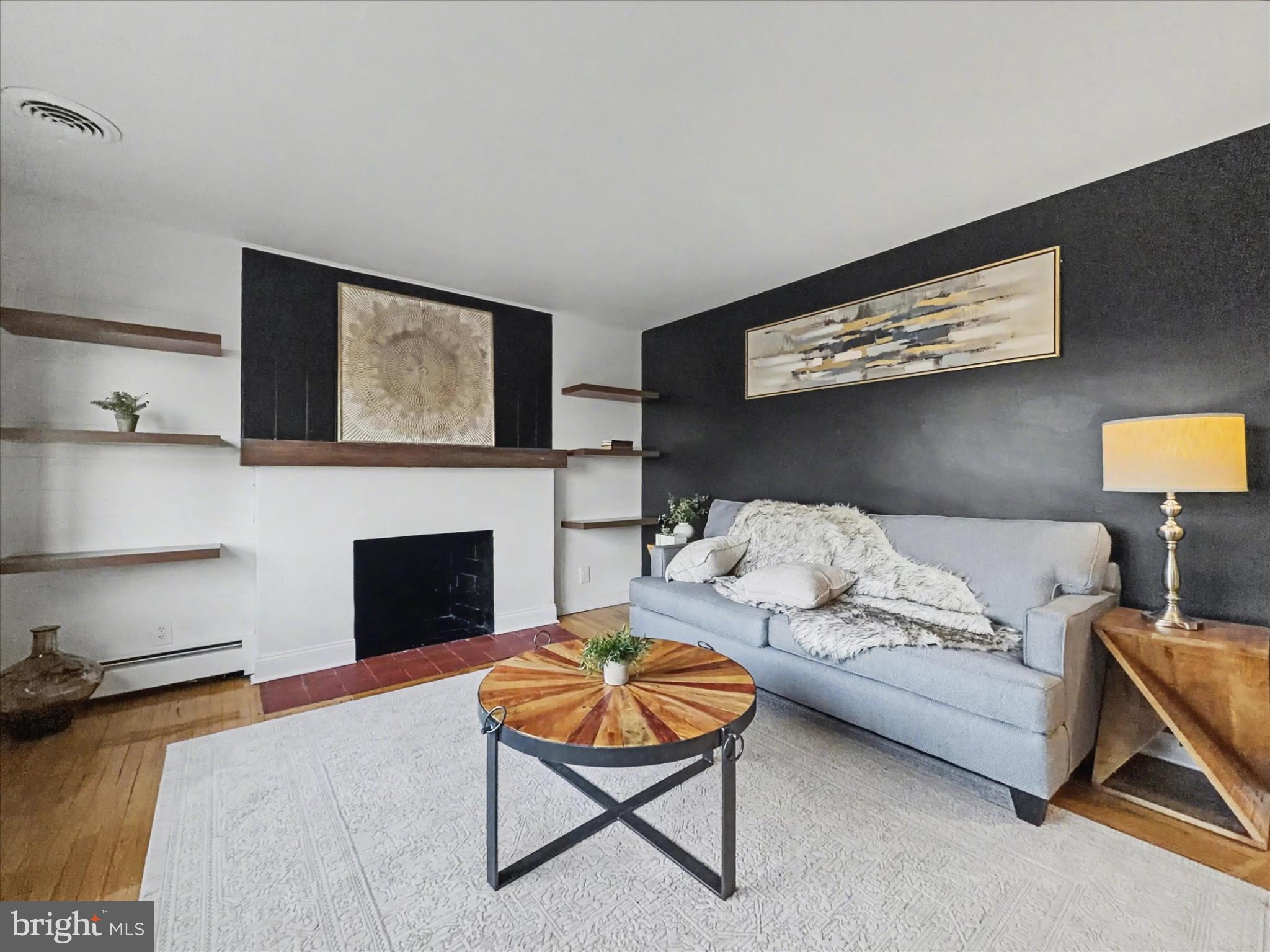 2196 South Queen Street York, PA 17402 - Photo 3 of 28 a living room with furniture a flat screen tv and a fireplace