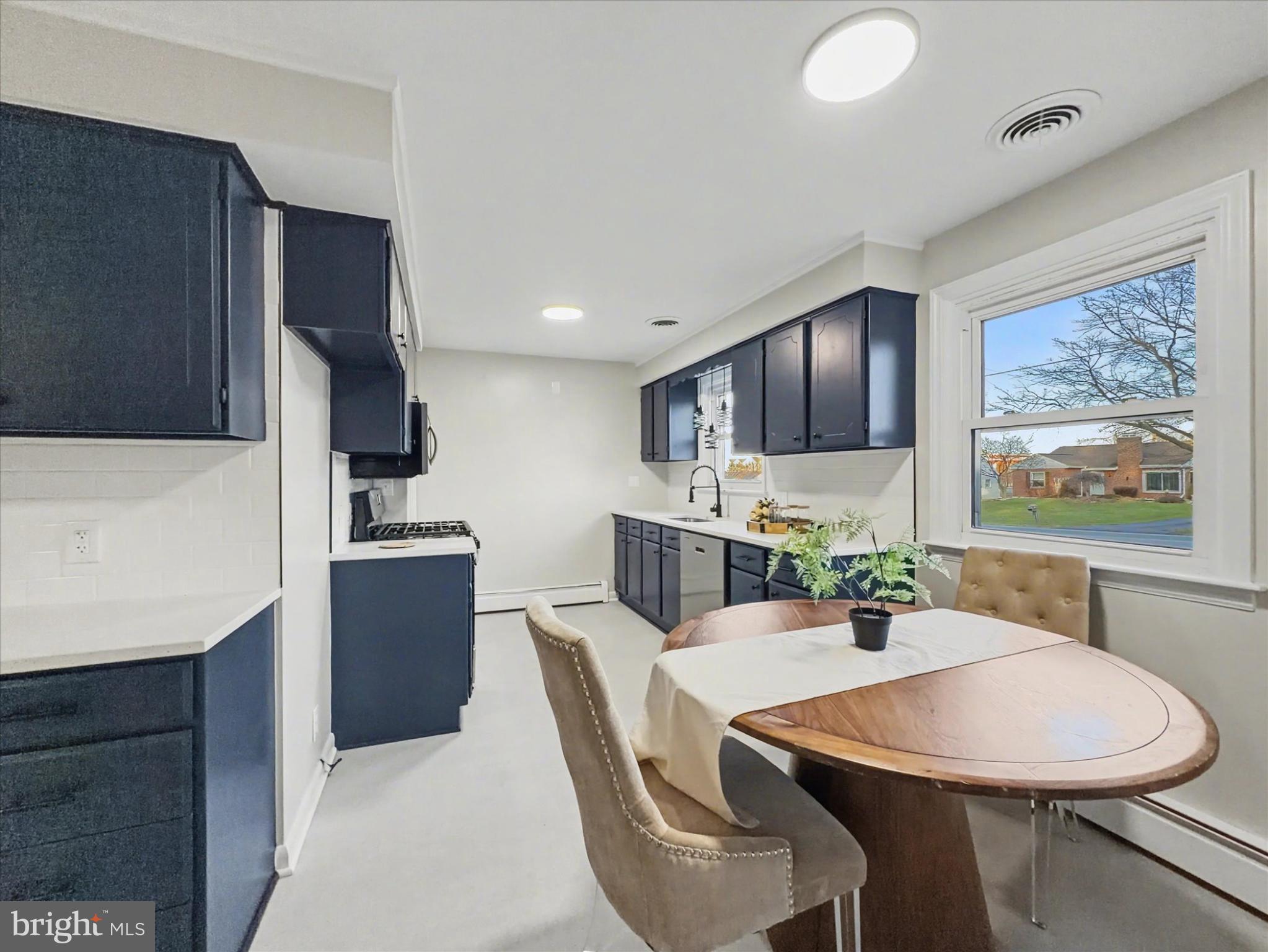 2196 South Queen Street York, PA 17402 - Photo 5 of 28 a kitchen with stainless steel appliances kitchen island granite countertop a sink a stove a dining table and chairs