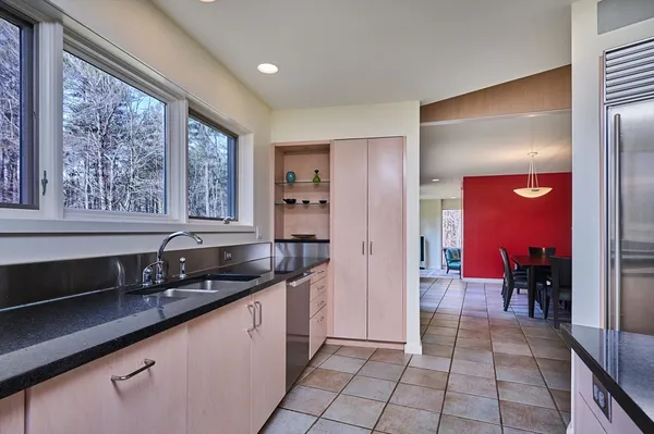 a kitchen with granite countertop a sink and a counter top space