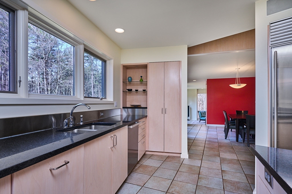 27 January Hills Road Amherst, MA 01002 - Photo 11 of 42 a kitchen with granite countertop a sink and a counter top space