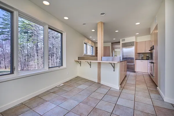 a kitchen with stainless steel appliances granite countertop a refrigerator and a stove top oven
