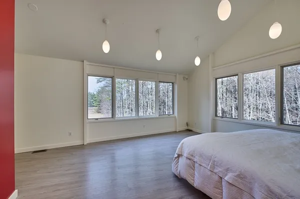 a spacious bedroom with a large bed and a large window