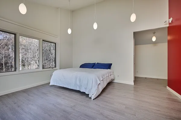 a bedroom with a bed and a large window