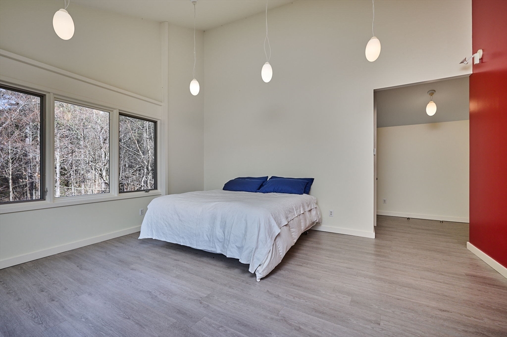 27 January Hills Road Amherst, MA 01002 - Photo 16 of 42 a bedroom with a bed and a large window