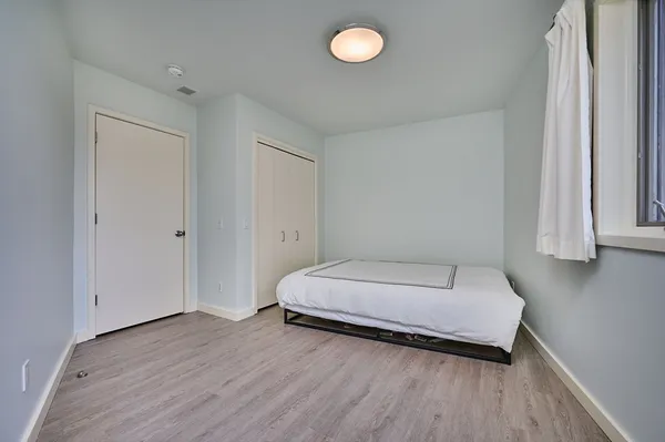 a bedroom with a bed and a window