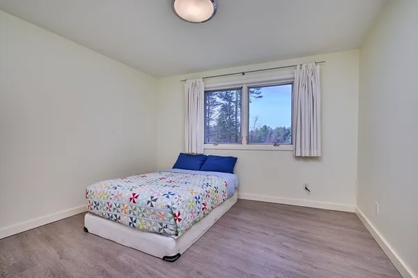 a bedroom with a bed and window