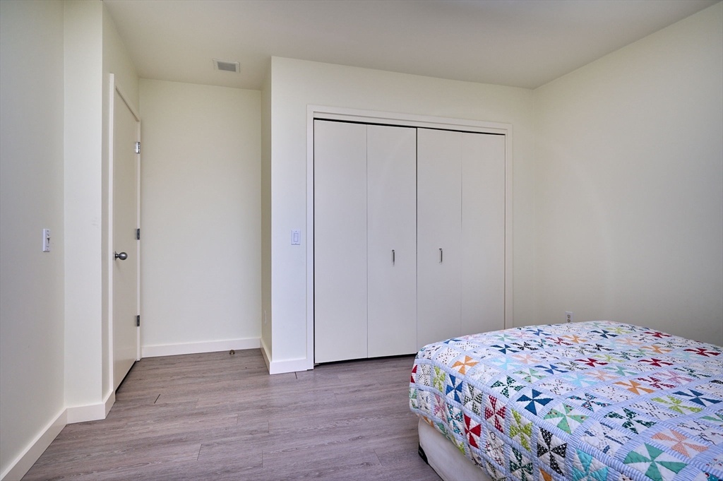 27 January Hills Road Amherst, MA 01002 - Photo 24 of 42 a bedroom with a bed and a gate