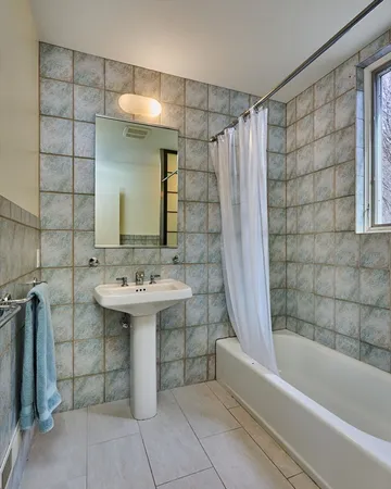 a bathroom with a sink a mirror and a bathtub