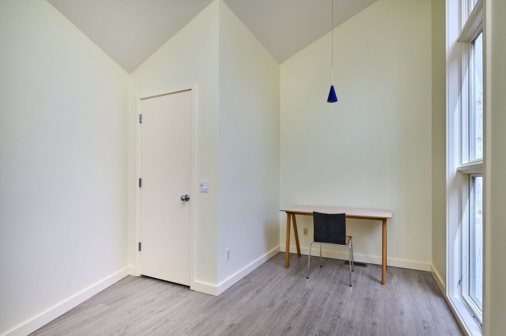 27 January Hills Road Amherst, MA 01002 - Photo 26 of 42 a view of an empty room with wooden floor and a window