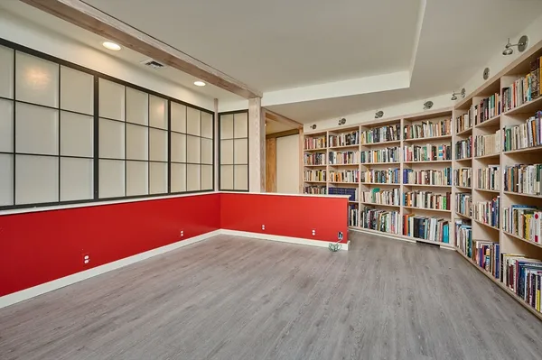 a view of an empty room with bookshelf