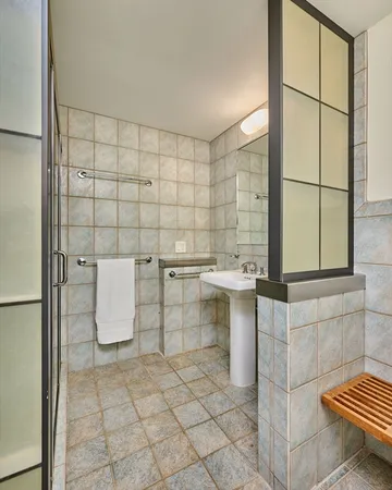 a bathroom with a sink toilet and shower
