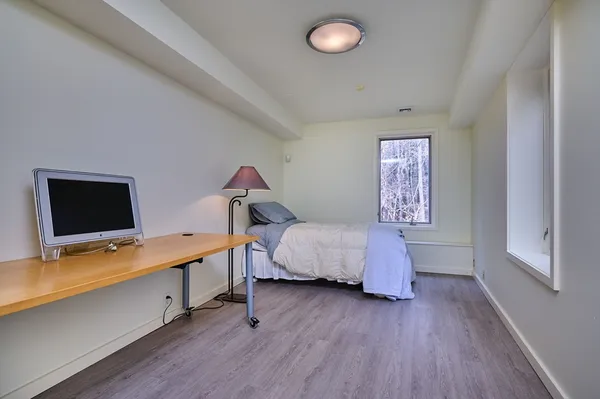 a bedroom with a bed and a flat screen tv