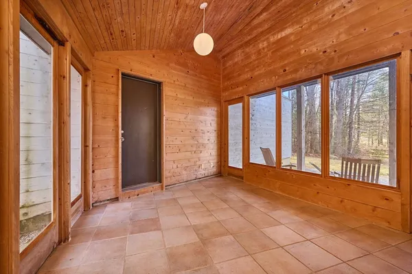 a view of an empty room with windows