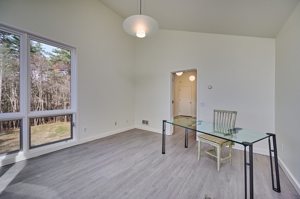 27 January Hills Road Amherst, MA 01002 - Photo 36 of 42 a view of an empty room with wooden floor and a window
