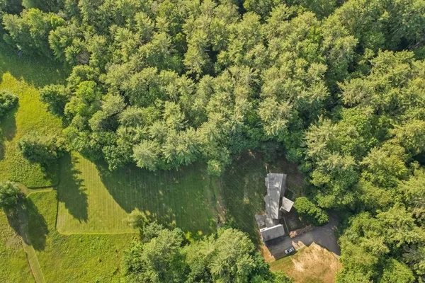 an aerial view of a houses with a yard
