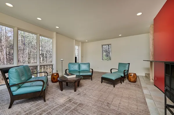 a living room with furniture and a lamp