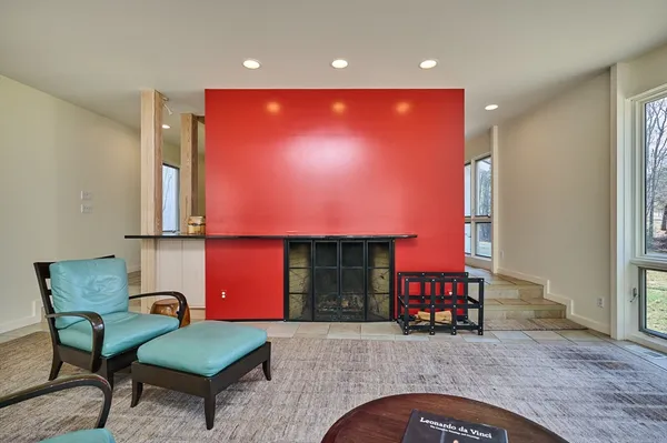 a living room with furniture pool table and outdoor view