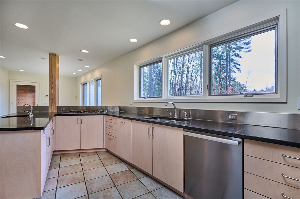 27 January Hills Road Amherst, MA 01002 - Photo 10 of 42 a kitchen with granite countertop a sink and a stove top oven