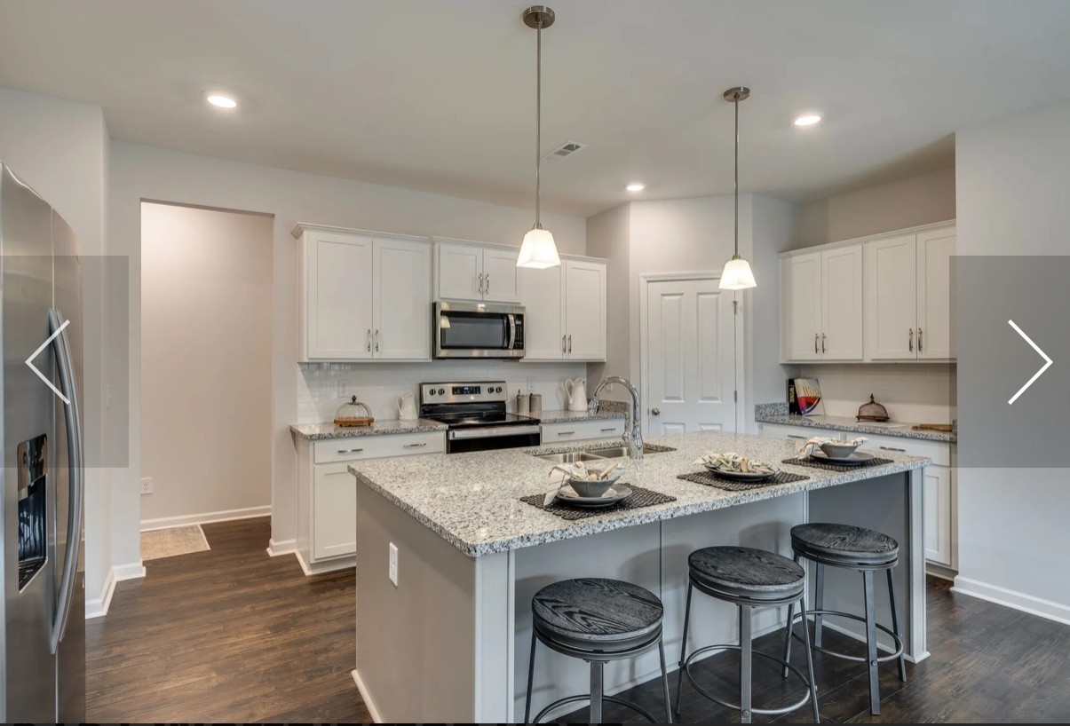 6161 Worthington Road Columbia, TN 38401 - Photo 12 of 33 a kitchen with sink a stove a refrigerator and chairs