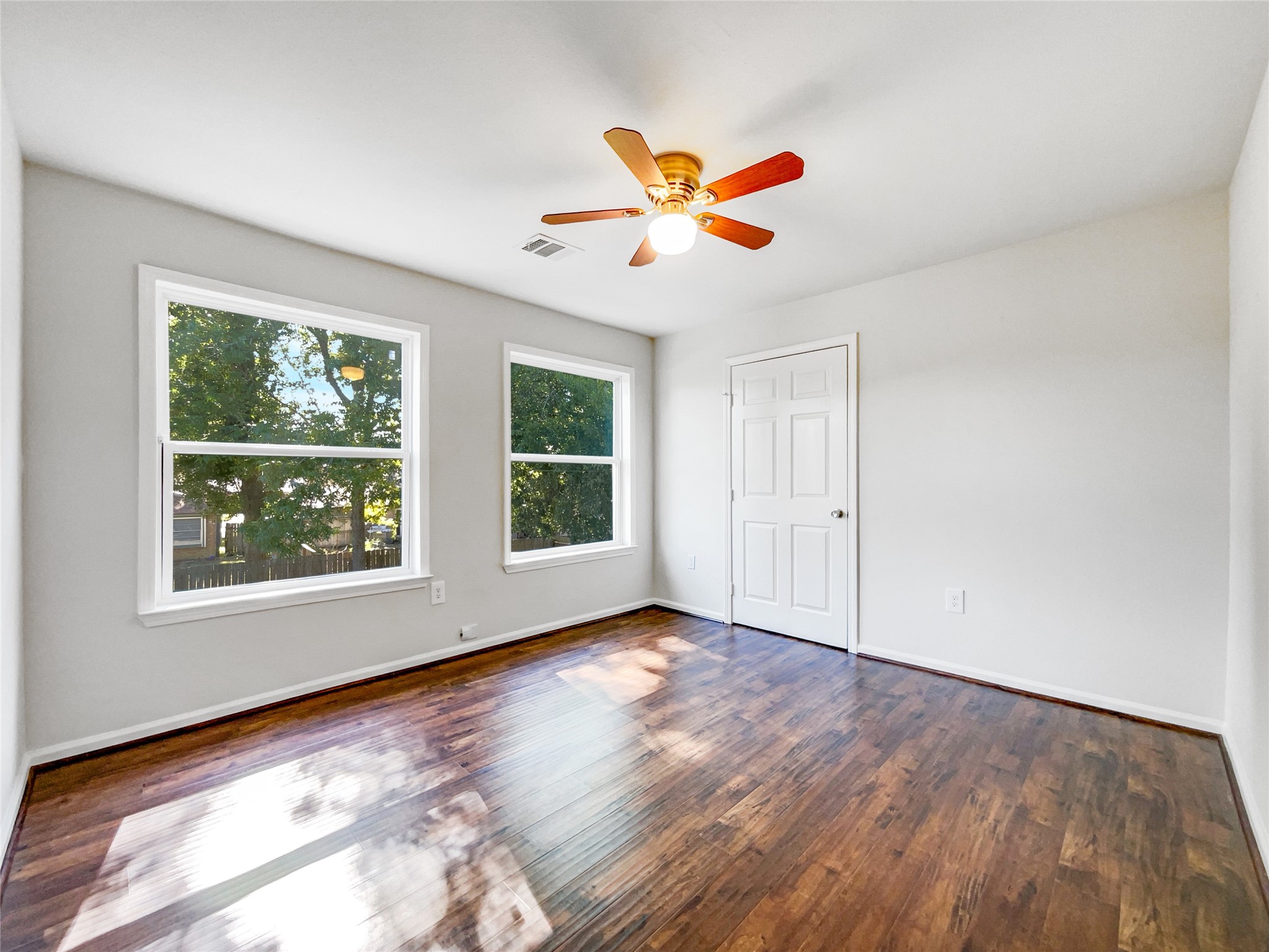 3407 Peachstone Place Spring, TX 77389 - Photo 14 of 17 a view of an empty room with wooden floor and a window