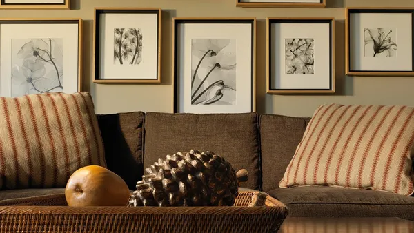 a living room with furniture and wall paintings