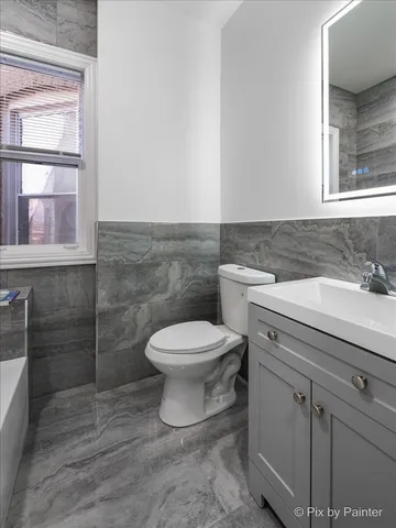 a bedroom with a bed and lamps