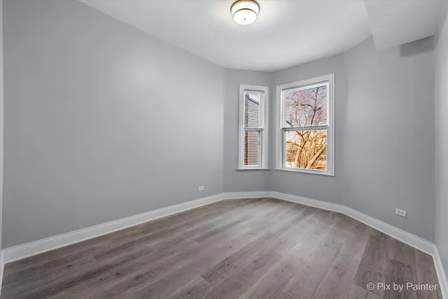 a kitchen with granite countertop a refrigerator and a stove top oven